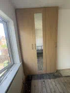 3 door wardrobes with a mirrored shaker door in the middle in Farerra Oak, fitted in Norton